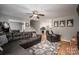 A cozy living room is complete with a ceiling fan, hardwood floors and a leather couch at 107 Ingonish Dr, Gastonia, NC 28056