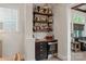 Chic bar area with custom shelving, mini-fridge, and stylish decor, perfect for entertaining guests at 1085 Wessington Manor Ln, Fort Mill, SC 29715