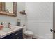 Stylish powder room with blue patterned wallpaper, white wainscoting, and a rustic wood-framed mirror at 1085 Wessington Manor Ln, Fort Mill, SC 29715