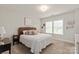 Neutral bedroom featuring carpet, a queen bed with wicker headboard, and lots of natural light at 1085 Wessington Manor Ln, Fort Mill, SC 29715