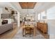 Open-concept dining area with a rustic table, hardwood floors, and views into the kitchen and living spaces at 1085 Wessington Manor Ln, Fort Mill, SC 29715