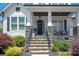 Inviting front entrance with stone steps, a black front door, and well-maintained landscaping at 1085 Wessington Manor Ln, Fort Mill, SC 29715
