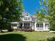 Charming two-story white home with a welcoming front porch and lush green lawn at 1085 Wessington Manor Ln, Fort Mill, SC 29715