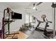 Home gym featuring a treadmill, weight rack, television and a ceiling fan at 1085 Wessington Manor Ln, Fort Mill, SC 29715
