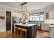Gourmet kitchen featuring a large island, white cabinetry, stainless steel appliances, and a stylish pendant lighting at 1085 Wessington Manor Ln, Fort Mill, SC 29715