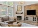 Bright and open living room featuring a fireplace, hardwood floors, large windows, and cozy furnishings at 1085 Wessington Manor Ln, Fort Mill, SC 29715