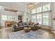 Spacious living room with a large sectional sofa, natural light, and an open layout leading to the dining area at 1085 Wessington Manor Ln, Fort Mill, SC 29715