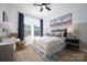 Bright bedroom with hardwood floors, white trim, and a ceiling fan at 11024 Shreveport Dr, Huntersville, NC 28078