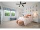 Cheerful bedroom with creative sailboat decor and ample natural light at 11024 Shreveport Dr, Huntersville, NC 28078
