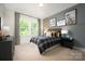 Charming bedroom with a plaid comforter, ample natural light, and lacrosse-themed decor at 11024 Shreveport Dr, Huntersville, NC 28078