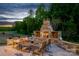 Outdoor stone fireplace and patio provide a cozy atmosphere for evening gatherings at 11024 Shreveport Dr, Huntersville, NC 28078