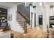 Inviting foyer showcasing modern staircase with wood treads and black railings, and a contrasting accent wall at 11024 Shreveport Dr, Huntersville, NC 28078
