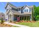 Stylish two-story home displaying a stone facade, well-manicured lawn and beautiful landscaping with a connecting walkway at 11024 Shreveport Dr, Huntersville, NC 28078