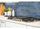 Close-up showcasing a modern gas cooktop, white countertops, and stylish backsplash at 11024 Shreveport Dr, Huntersville, NC 28078