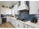 Well-appointed kitchen featuring white cabinets, stainless steel appliances, and a sleek cooktop at 11024 Shreveport Dr, Huntersville, NC 28078