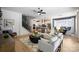 Open-concept living area flowing into kitchen and dining, with cozy seating, modern decor, and wood flooring at 11024 Shreveport Dr, Huntersville, NC 28078