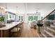 Bright, open-concept kitchen and living area with hardwood floors, modern fixtures, and ample natural light at 11024 Shreveport Dr, Huntersville, NC 28078