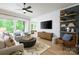Inviting living room with TV, shelving, decor and a view through sliding doors to a patio with outdoor seating at 11024 Shreveport Dr, Huntersville, NC 28078