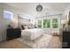 Bright main bedroom featuring a neutral palette, large windows, and a decorative light fixture at 11024 Shreveport Dr, Huntersville, NC 28078