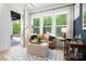 Cozy sitting room with views of the deck, featuring comfortable leather sofa, ottoman, and stylish decor at 11024 Shreveport Dr, Huntersville, NC 28078