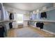 Spacious walk-in closet with custom shelving, natural light, and a stylish rug at 11024 Shreveport Dr, Huntersville, NC 28078