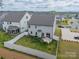 Aerial view of backyard with a white fence and grassy lawn, plus a patio area at 113 Summerhill Dr, Mooresville, NC 28115