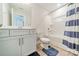 Bathroom featuring a light blue vanity, shower-tub combination, and modern fixtures at 113 Summerhill Dr, Mooresville, NC 28115