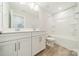 Bright bathroom featuring double sink vanity with shaker cabinets and tub and shower combination at 113 Summerhill Dr, Mooresville, NC 28115