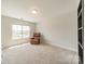 Neutral bedroom features plush carpet, a cozy chair, and a bright window for natural light at 113 Summerhill Dr, Mooresville, NC 28115
