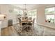 Bright dining area with modern round table, stylish rug and outdoor access at 113 Summerhill Dr, Mooresville, NC 28115