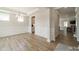 Dining room with hardwood floors and modern chandelier with kitchen view at 113 Summerhill Dr, Mooresville, NC 28115
