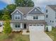 Two-story home with blue and gray siding, stone accents, and a two-car garage at 113 Summerhill Dr, Mooresville, NC 28115
