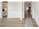 Long hallway featuring hardwood floors, white walls, and trimwork at 113 Summerhill Dr, Mooresville, NC 28115