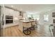 Open kitchen with island, white cabinets, stainless steel appliances, and eating area at 113 Summerhill Dr, Mooresville, NC 28115