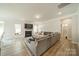 Spacious living room featuring a fireplace, large sectional, and natural light at 113 Summerhill Dr, Mooresville, NC 28115