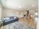 Cozy living room with hardwood floors, a plush couch and staircase leading to the upper level at 113 Summerhill Dr, Mooresville, NC 28115