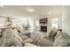 Large living space with TV over fireplace leading into bright kitchen and dining area at 113 Summerhill Dr, Mooresville, NC 28115