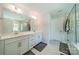 Bright main bathroom boasts double sinks, sleek white cabinets, and a luxurious glass enclosed shower at 113 Summerhill Dr, Mooresville, NC 28115
