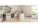 Home office featuring a mini fridge, modern white desk, and decorative shelving and lighting at 113 Summerhill Dr, Mooresville, NC 28115