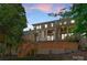 Multi-level back exterior featuring patios, brick accents, and lush landscaping at 1160 S Kings Dr, Charlotte, NC 28207