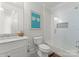 A well lit bathroom with framed art, modern vanity, and tub and shower with glass door at 1160 S Kings Dr, Charlotte, NC 28207