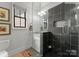 A charming bathroom with contrasting tile in the walk-in shower and a modern vanity with stone countertop at 1160 S Kings Dr, Charlotte, NC 28207