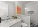 This well lit bathroom features a modern vanity, framed art, and glass enclosed shower at 1160 S Kings Dr, Charlotte, NC 28207