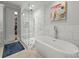 This bathroom features a glass-enclosed shower, soaking tub, and marble tile at 1160 S Kings Dr, Charlotte, NC 28207