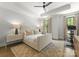 Bright bedroom includes hardwood floors, a ceiling fan, and large windows at 1160 S Kings Dr, Charlotte, NC 28207