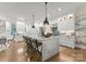 Modern kitchen with an island, bar stool seating, and sleek appliances open to the great room at 1160 S Kings Dr, Charlotte, NC 28207