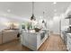 Open kitchen featuring a central island, stainless steel appliances, and seamless living room access at 1160 S Kings Dr, Charlotte, NC 28207