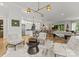 Spacious living room open to kitchen boasts stylish lighting and contemporary furnishings at 1160 S Kings Dr, Charlotte, NC 28207