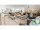 Spacious living room boasts a large sectional sofa, light-toned rug, and view of the kitchen area at 1160 S Kings Dr, Charlotte, NC 28207