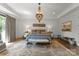 Luxurious main bedroom with a chandelier, tray ceiling, and elegant decor, creating a serene and stylish retreat at 1160 S Kings Dr, Charlotte, NC 28207